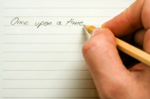 Hand holding a pen over paper.